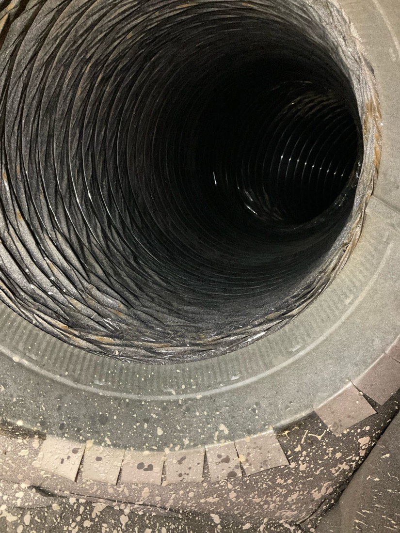 Interior view of cleaned flexible ductwork showing metal spiral ridges.