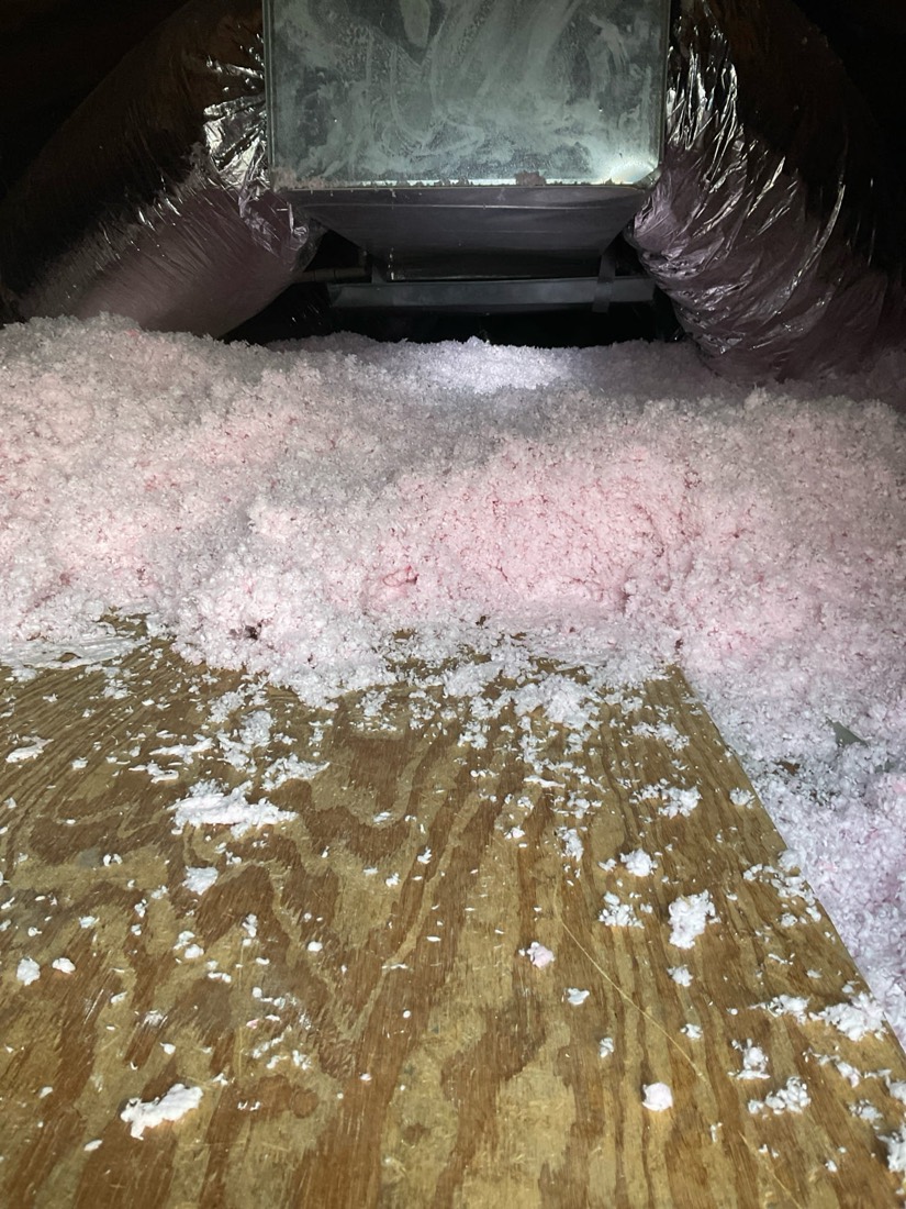Pink insulation batts installed in attic adjacent to HVAC ductwork