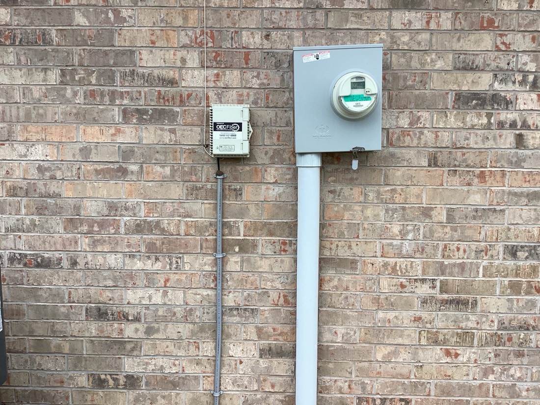 Electrical meter and service disconnect on brick wall