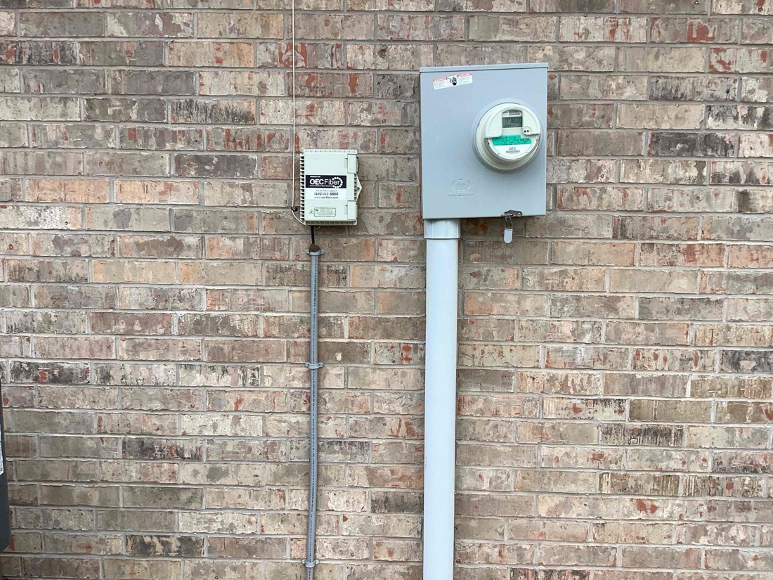 Installed electrical meter on brick exterior wall