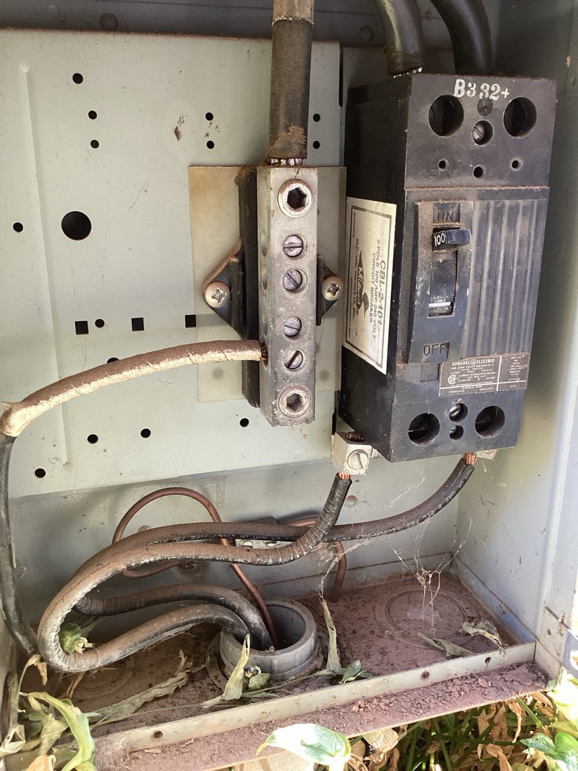 Electrical circuit breaker panel with organized wiring connections.