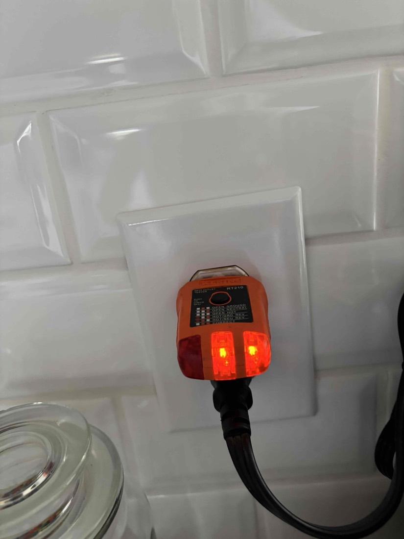 Newly installed GFCI outlet with safety test indicator lights.