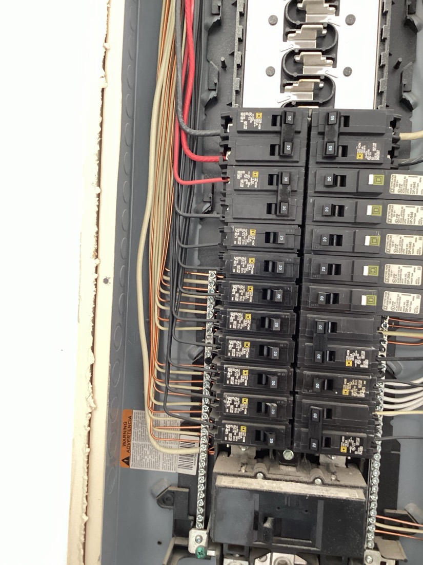 Electrical panel with organized circuit breakers and wiring
