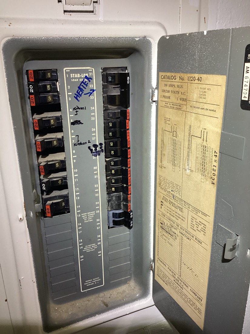 Modern electrical panel with organized breakers and wiring schematic.