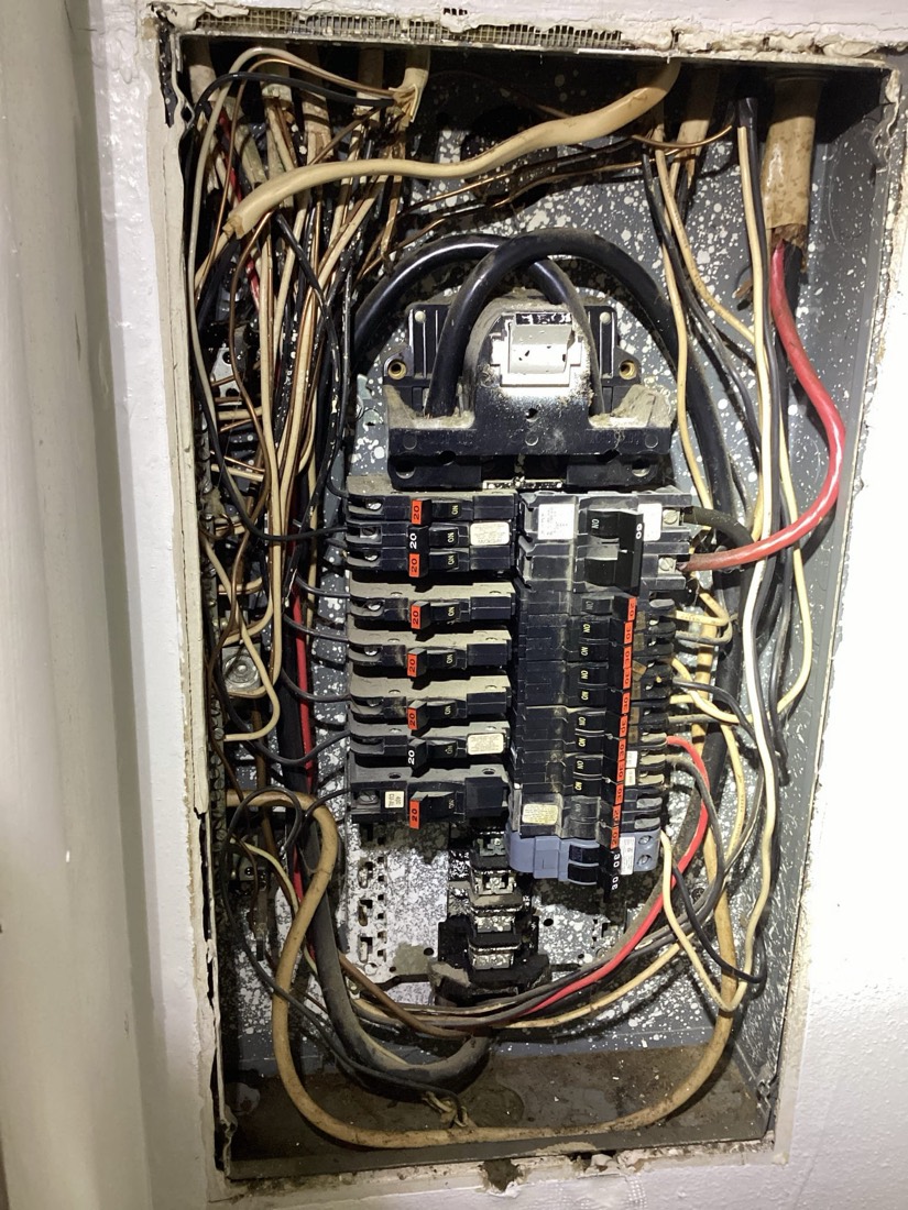 Completed electrical service panel with breakers and main disconnect.