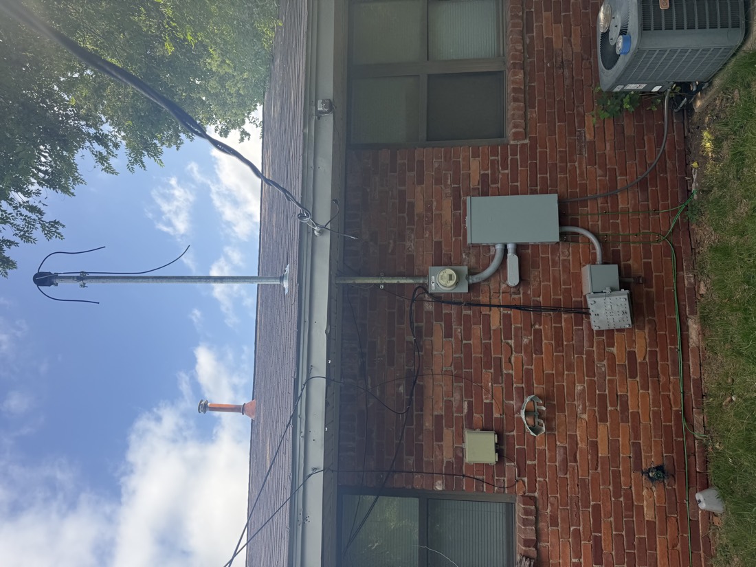 Electrical meter and service panel on residential brick wall