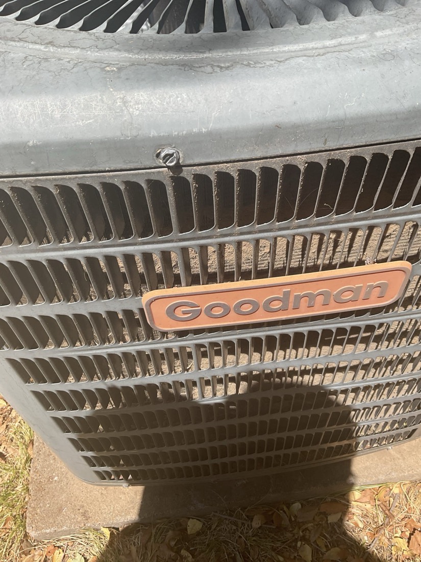 Goodman condenser unit with aluminum fins, front view.