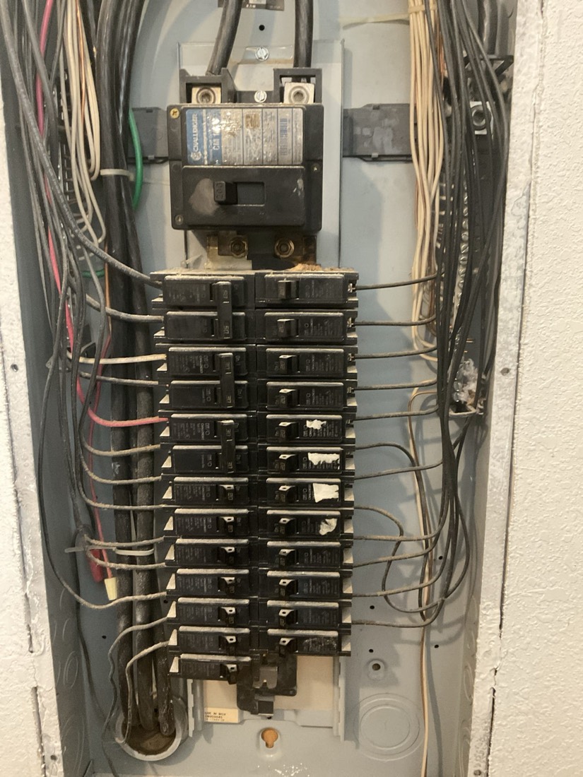 Electrical panel with organized breaker switches and properly arranged wiring.