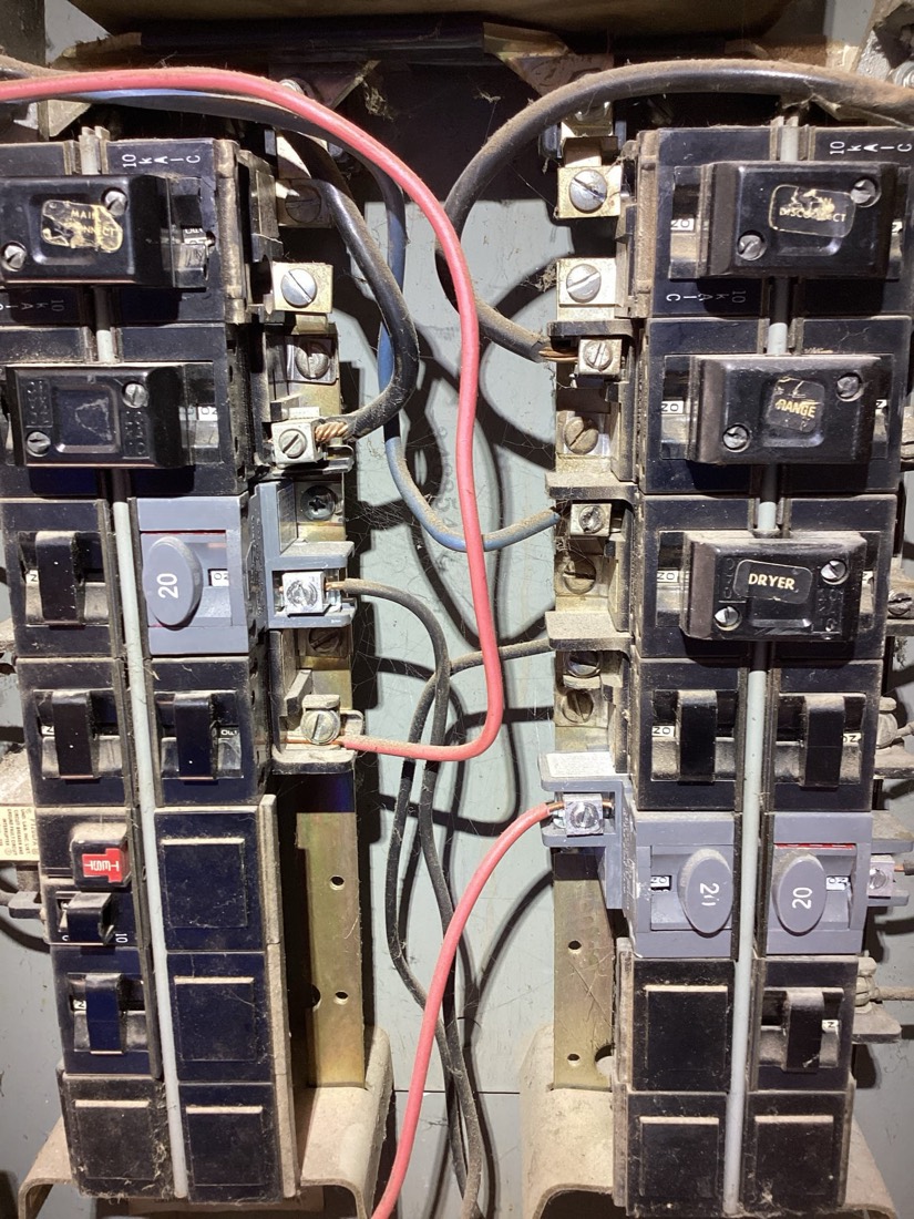 Two electrical panels with new breakers and organized wiring installation.