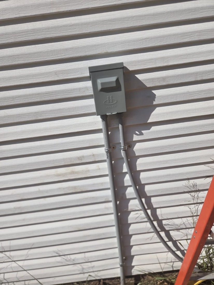 Installed electrical disconnect switch on metal siding
