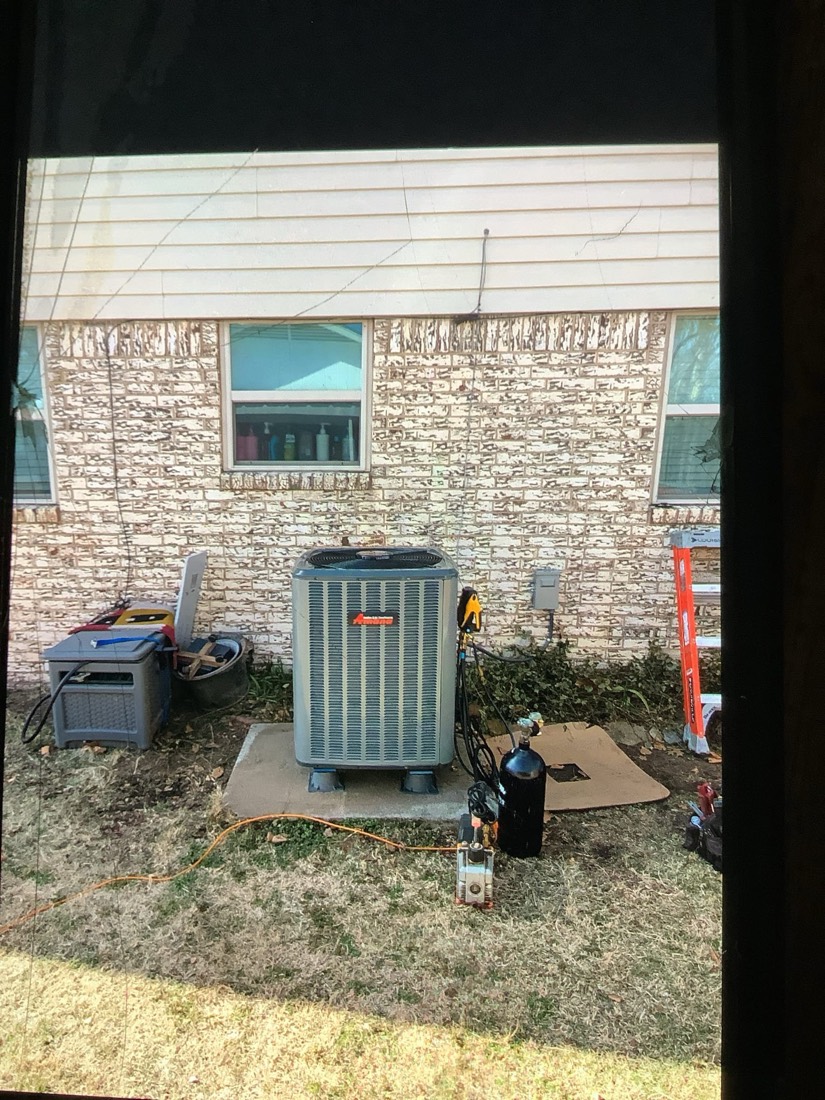 Complete HVAC condenser unit installation with service disconnect.