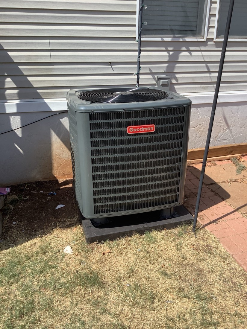 New Goodman AC condenser unit installed outdoors