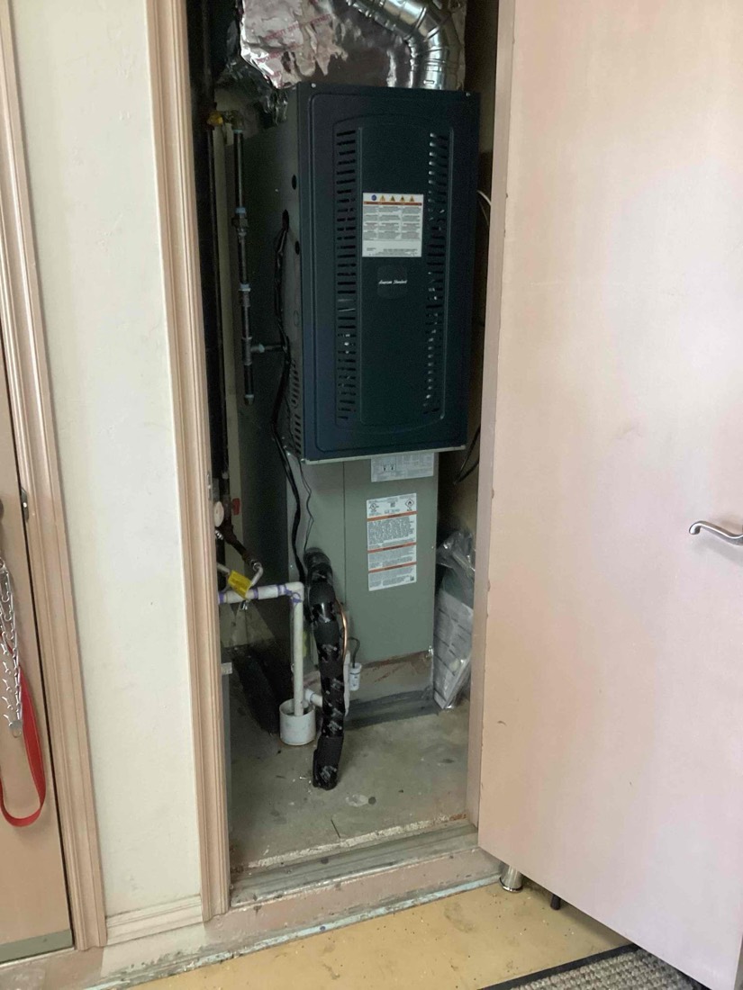New HVAC furnace and coil system installed in basement utility space.