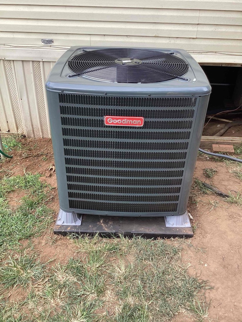 New Goodman AC condenser unit installed on concrete pad
