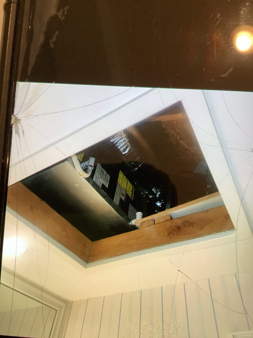 New HVAC furnace unit mounted in attic cavity.