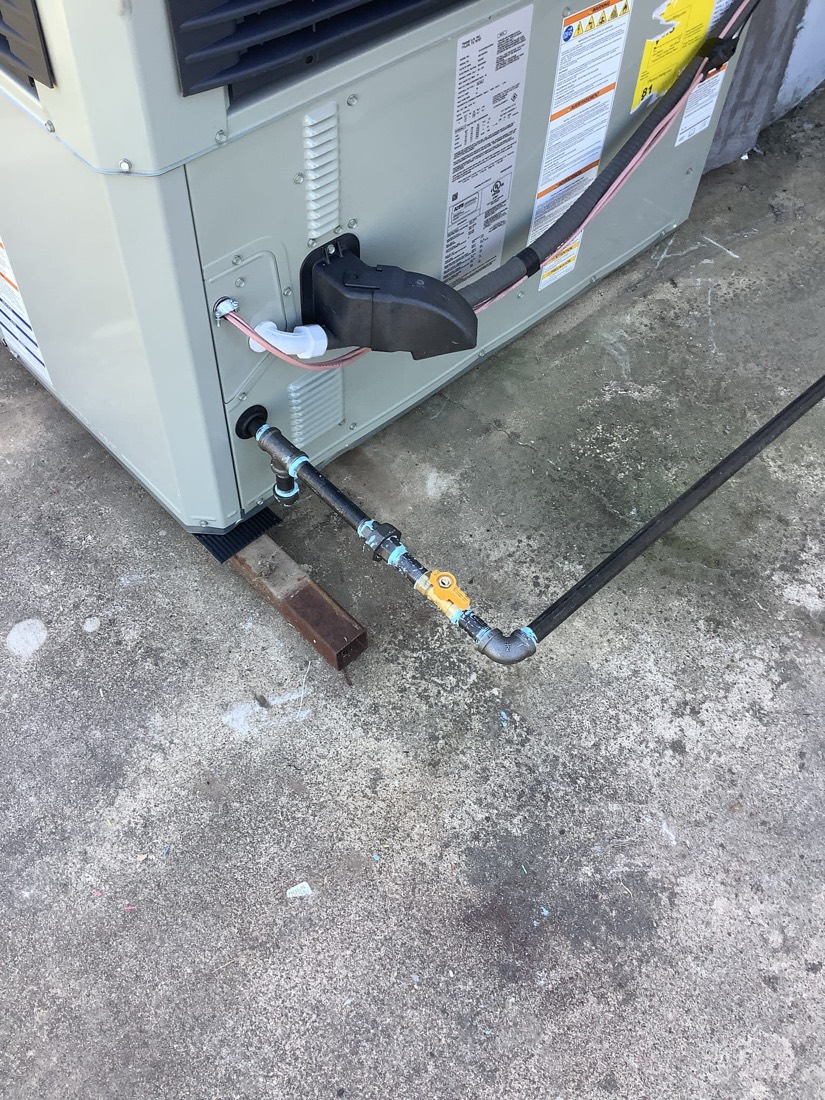 Newly installed outdoor HVAC condensing unit with connections