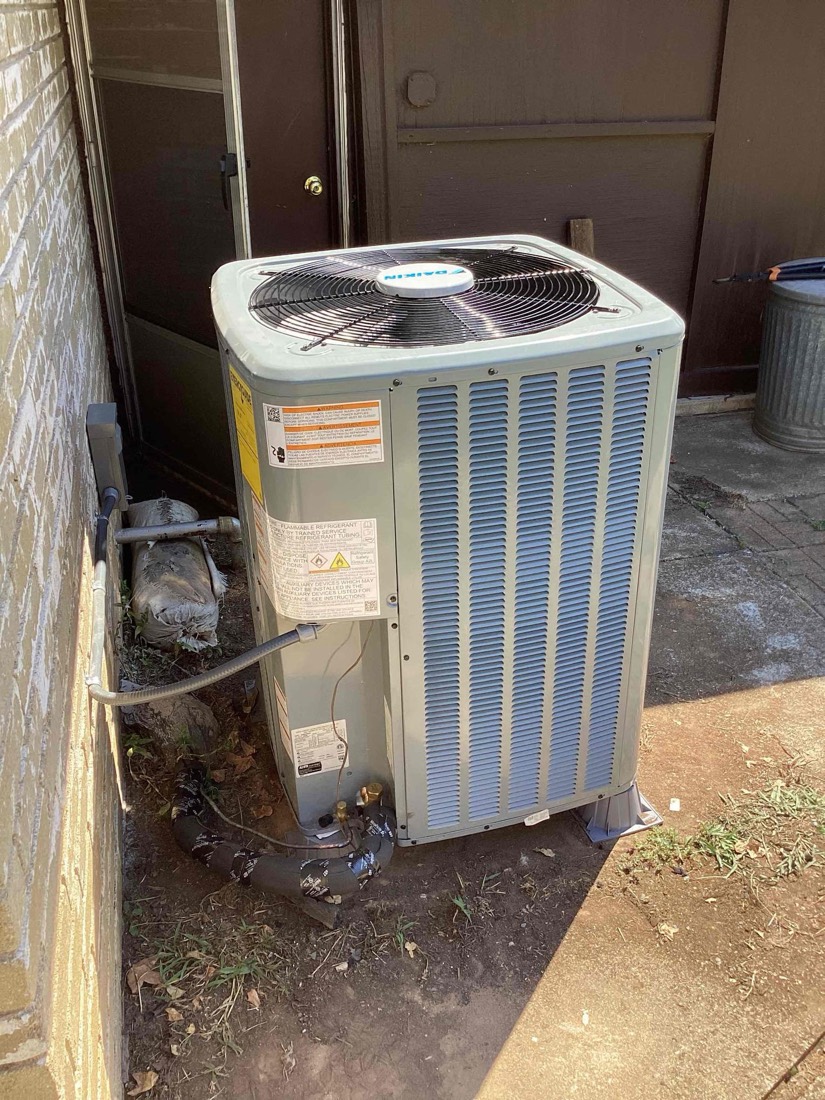 Outdoor AC condenser unit installation.