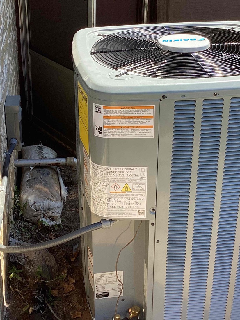 AC condenser with refrigerant lines installed.