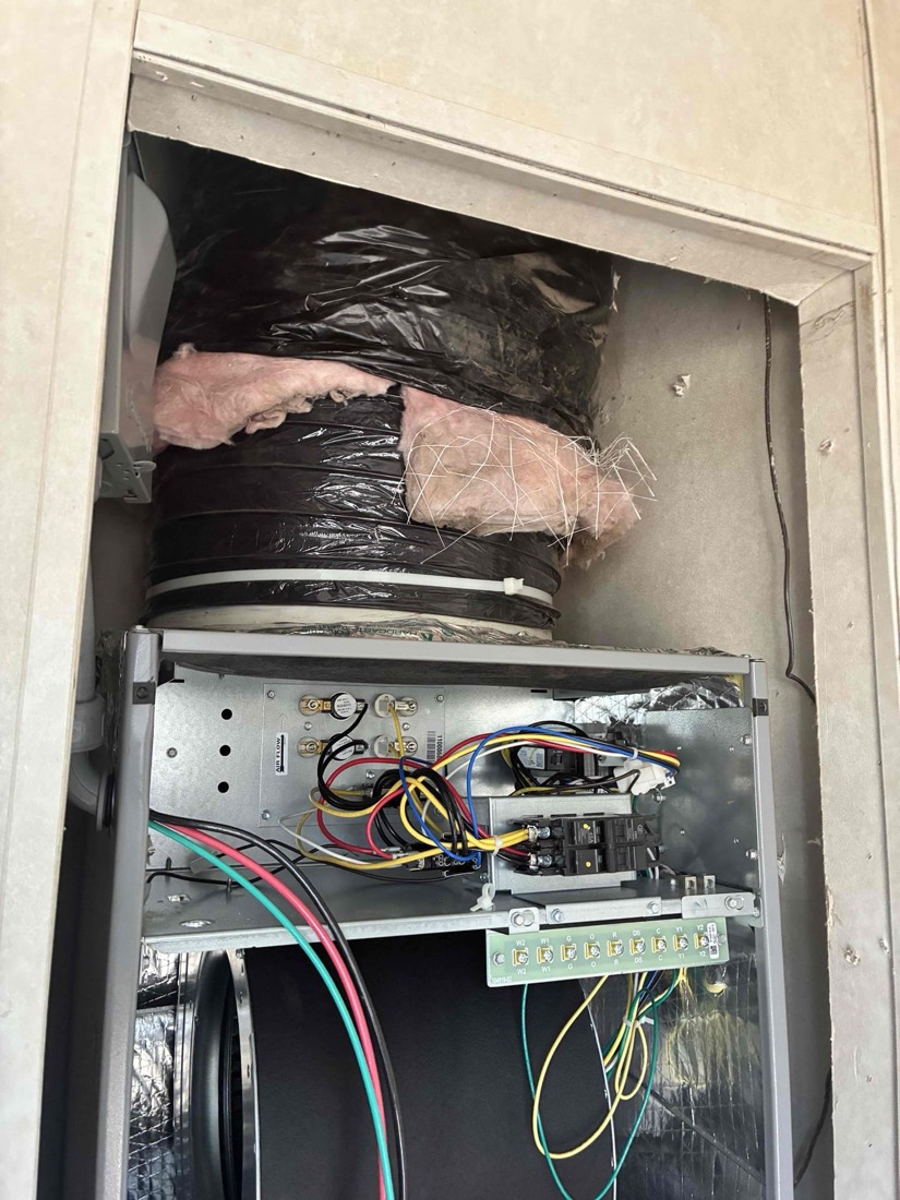 New HVAC air handler with insulated ducts and electrical wiring installed