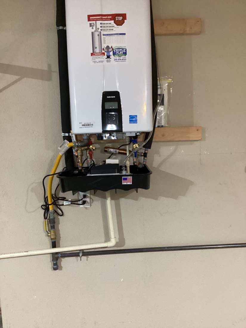 Installed tankless water heater with brass fittings and gas supply